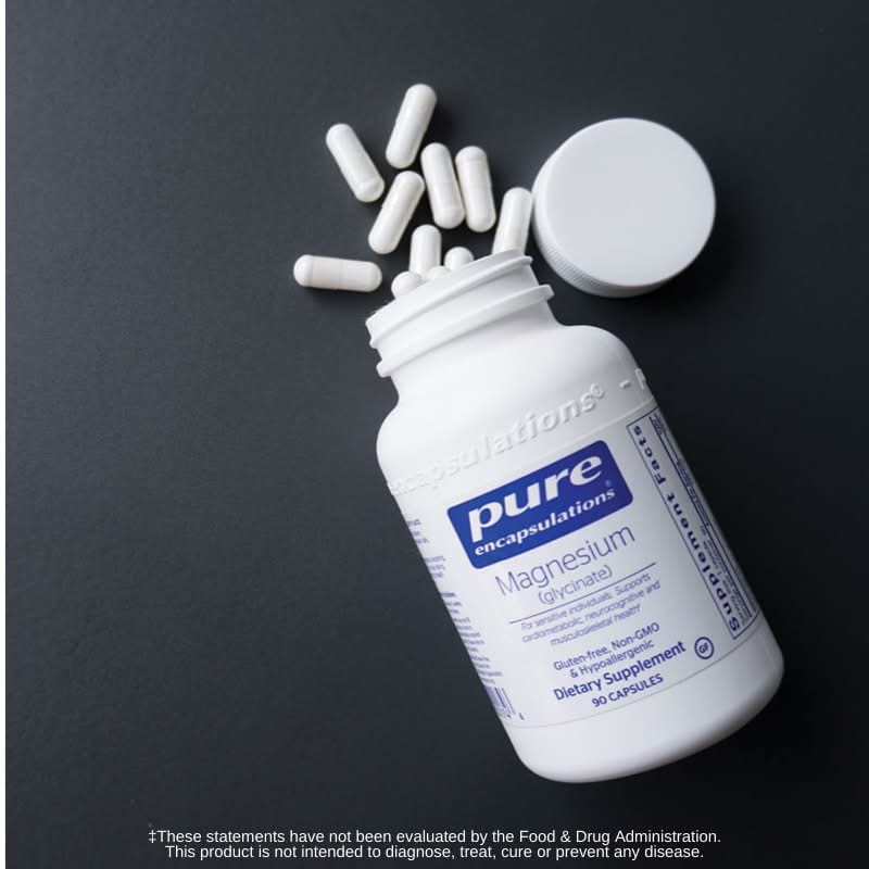 Pure Encapsulations Magnesium glycinate bottle and capsules on a dark background